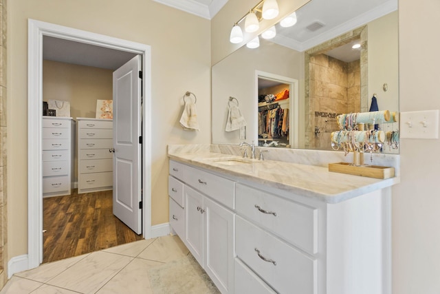 bathroom with vanity, wood-type flooring, and ornamental molding