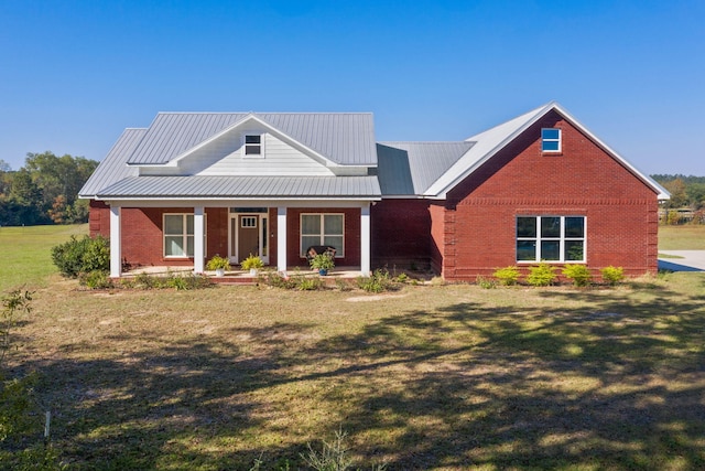 view of front of home with covered porch and a front lawn