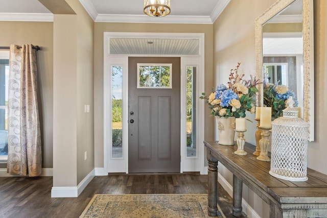 foyer entrance with ornamental molding, an inviting chandelier, and dark hardwood / wood-style floors