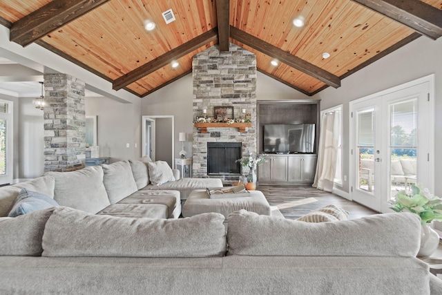 living room featuring wood ceiling, a healthy amount of sunlight, and light wood-type flooring