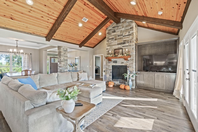 living room with wood ceiling, a stone fireplace, high vaulted ceiling, light hardwood / wood-style flooring, and an inviting chandelier