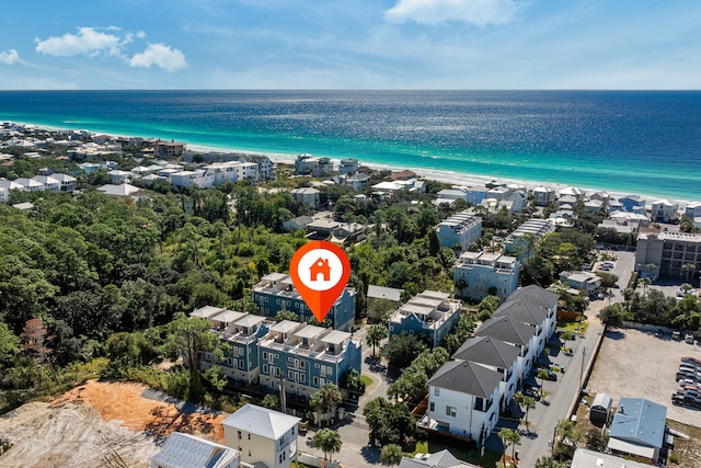 birds eye view of property featuring a water view and a beach view