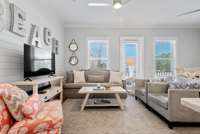 living room featuring crown molding, a healthy amount of sunlight, and ceiling fan