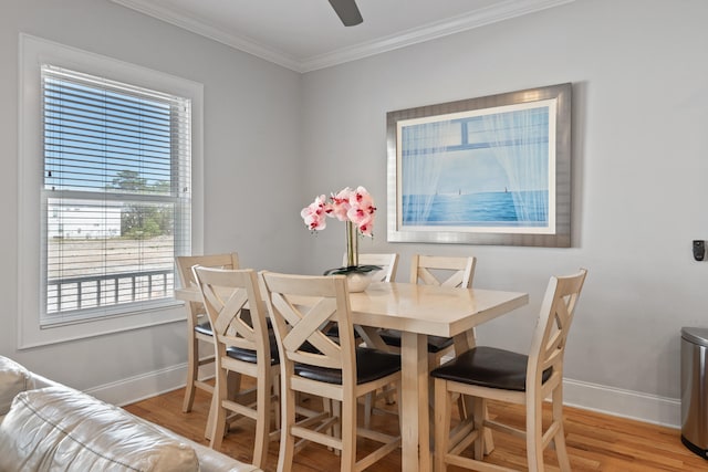 dining area featuring light hardwood / wood-style floors and crown molding