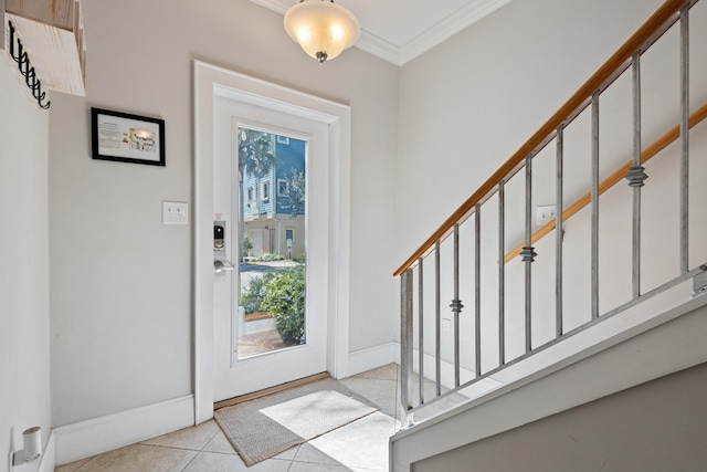 tiled foyer featuring ornamental molding