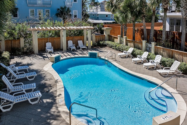 view of swimming pool featuring a patio and a pergola