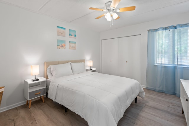 209 W Miracle Strip Pkwy Unit J201, Mary Esther, FL 32569 - bedroom with baseboards, wood finished floors, ceiling fan, and a closet