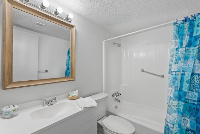 full bathroom featuring vanity, toilet, a textured ceiling, and shower / tub combo