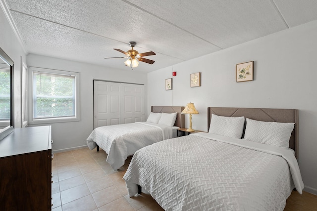 209 W Miracle Strip Pkwy Unit J201, Mary Esther, FL 32569 - bedroom with light tile patterned floors, a closet, ceiling fan, and baseboards