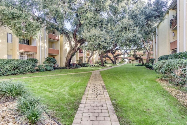 209 W Miracle Strip Pkwy Unit J201, Mary Esther, FL 32569 - view of property's community featuring a lawn and a residential view