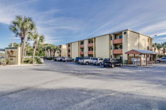 209 W Miracle Strip Pkwy Unit J201, Mary Esther, FL 32569 - view of building exterior with uncovered parking