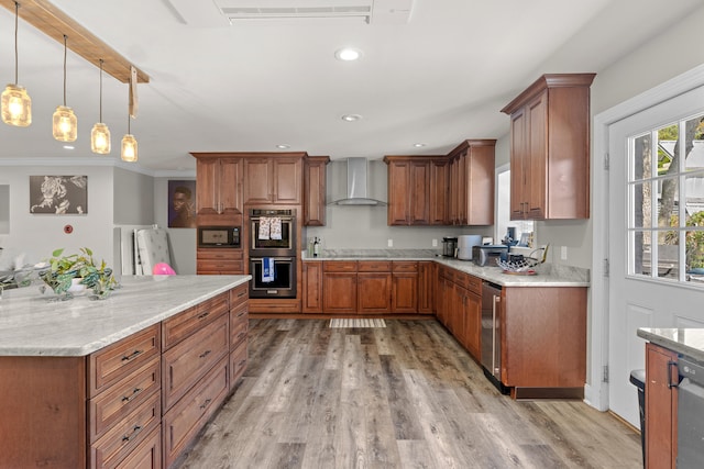 kitchen featuring light stone countertops, light wood-type flooring, wall chimney exhaust hood, stainless steel appliances, and decorative light fixtures