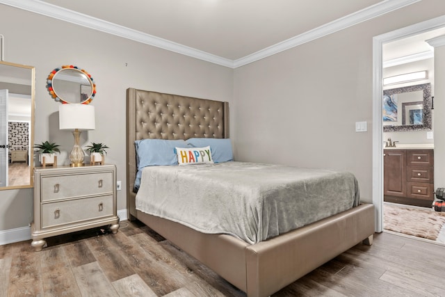 bedroom featuring hardwood / wood-style flooring, sink, and crown molding