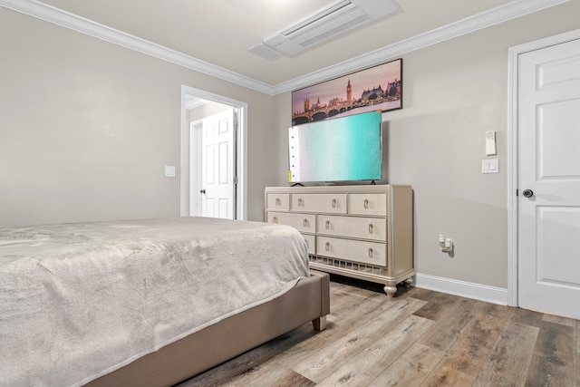 bedroom with light hardwood / wood-style flooring and ornamental molding