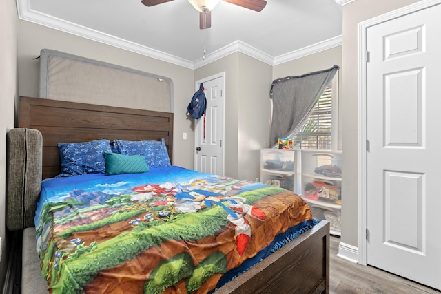 bedroom featuring ceiling fan, crown molding, and hardwood / wood-style flooring