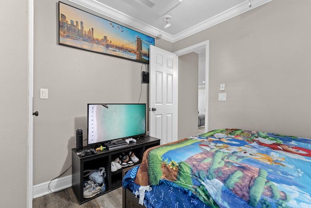 bedroom with hardwood / wood-style flooring and ornamental molding