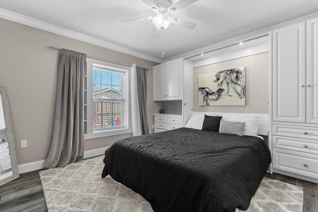 bedroom with ornamental molding, ceiling fan, and dark wood-type flooring