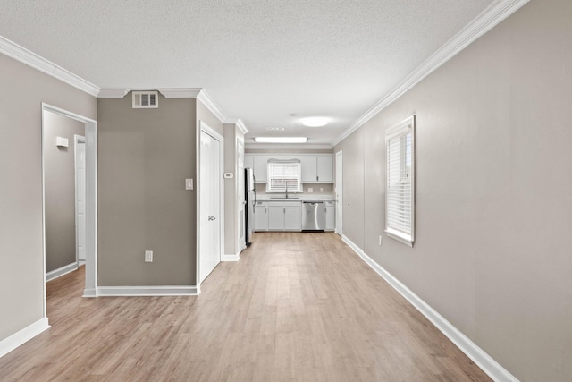 hallway featuring a textured ceiling, light hardwood / wood-style flooring, and ornamental molding