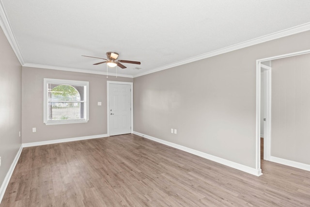 empty room featuring ceiling fan, crown molding, and light hardwood / wood-style floors