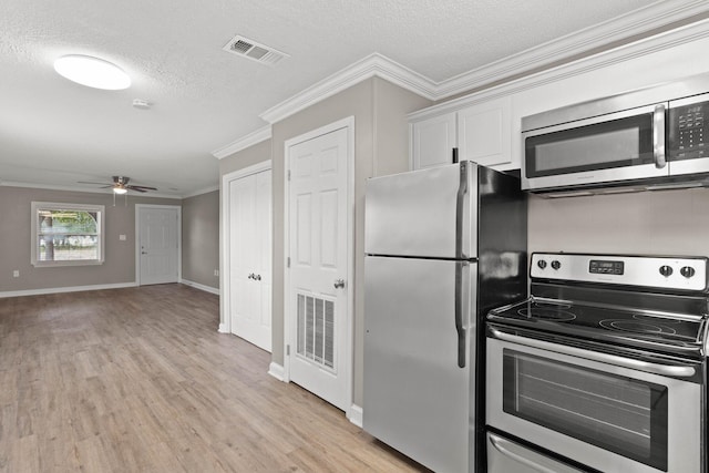 kitchen with white cabinetry, ceiling fan, a textured ceiling, appliances with stainless steel finishes, and ornamental molding