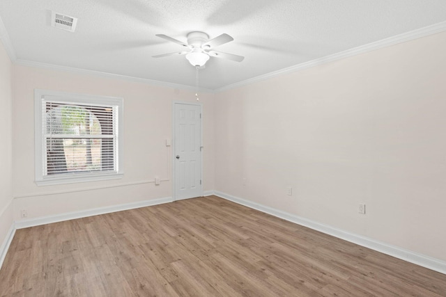 empty room featuring crown molding, ceiling fan, a textured ceiling, and light wood-type flooring