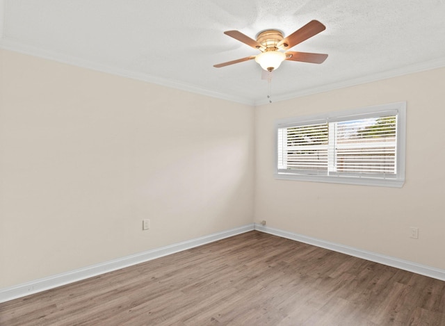 spare room with hardwood / wood-style flooring, ceiling fan, and ornamental molding