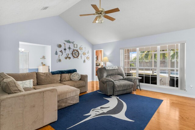 living room with hardwood / wood-style flooring, high vaulted ceiling, and ceiling fan