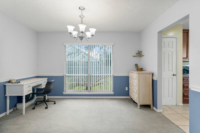 carpeted office with a notable chandelier and a textured ceiling