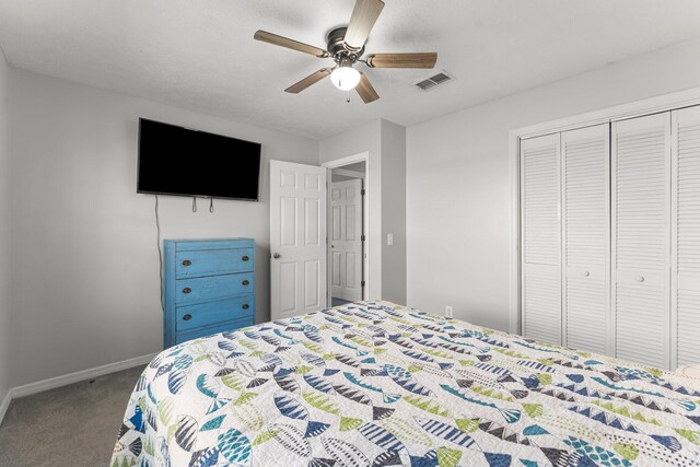 carpeted bedroom featuring a closet and ceiling fan