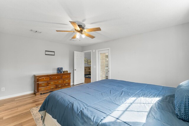 bedroom with ceiling fan, wood-type flooring, and ensuite bath