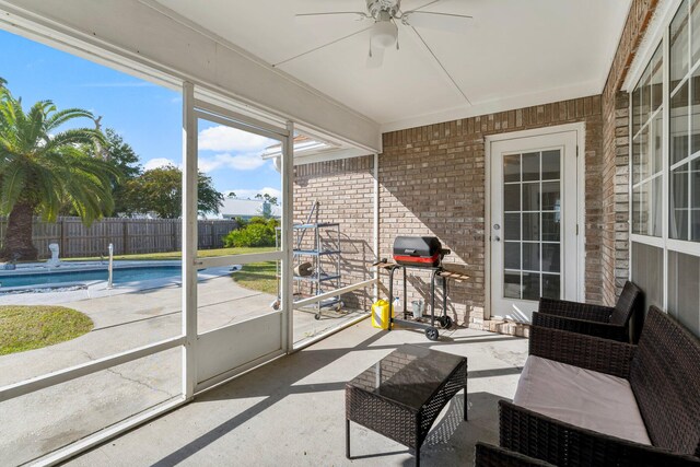 sunroom / solarium featuring ceiling fan