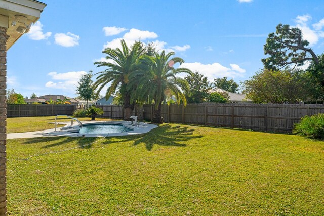 view of yard with a fenced in pool