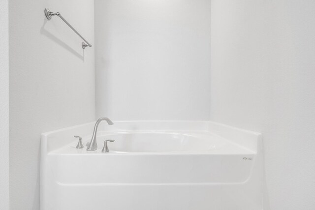 bathroom with a tub to relax in