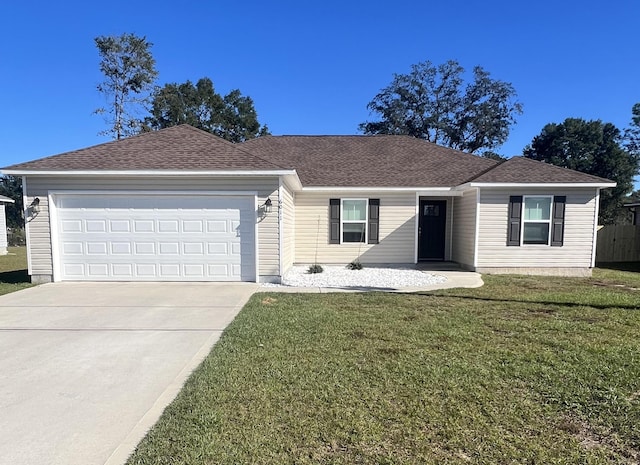 single story home featuring a garage and a front yard