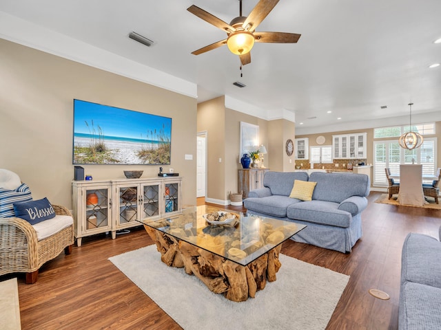 living room featuring ceiling fan and dark wood-type flooring