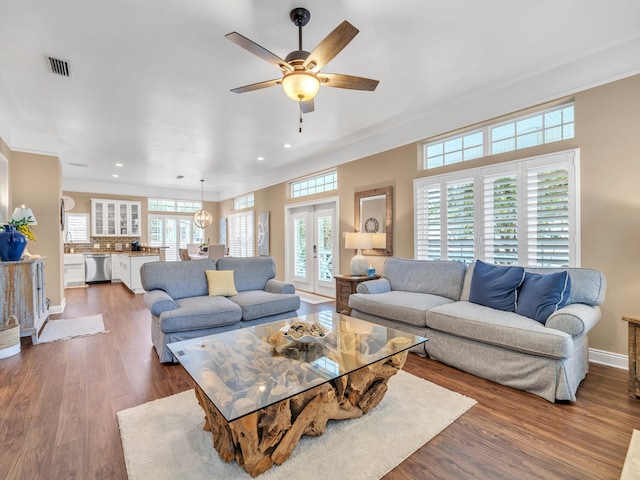 living room featuring french doors, ceiling fan, and dark wood-type flooring