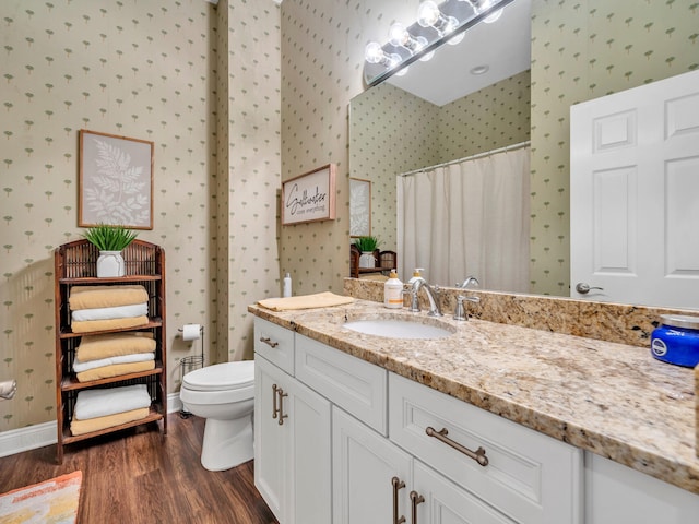 bathroom featuring a shower with curtain, toilet, vanity, and hardwood / wood-style flooring