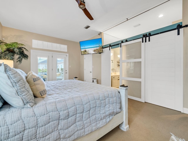 bedroom with access to outside, ensuite bathroom, ceiling fan, a barn door, and carpet floors