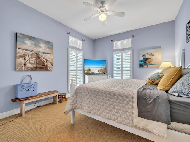 bedroom featuring multiple windows, light colored carpet, and ceiling fan