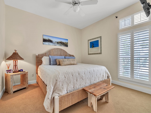 carpeted bedroom featuring ceiling fan and multiple windows