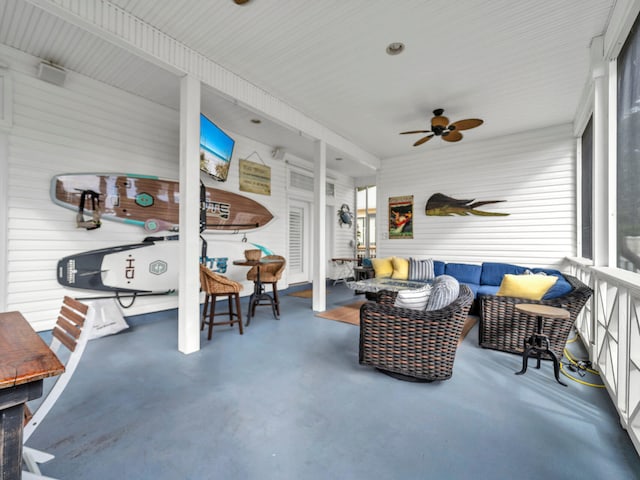 sunroom featuring ceiling fan