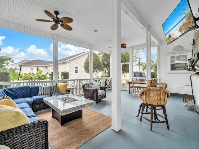 sunroom featuring ceiling fan and lofted ceiling