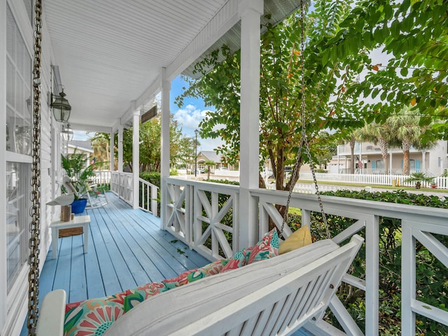 wooden terrace featuring covered porch