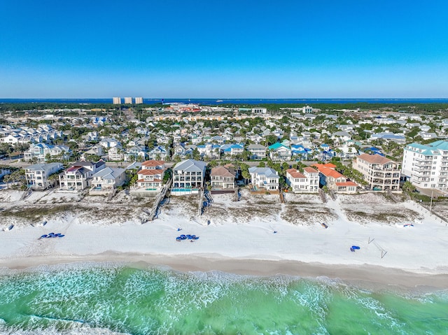 drone / aerial view featuring a water view and a view of the beach