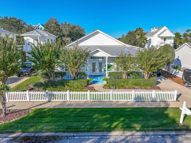 view of front facade featuring french doors and a front lawn