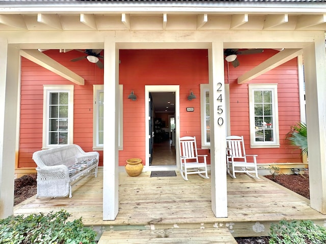 wooden deck with covered porch and ceiling fan