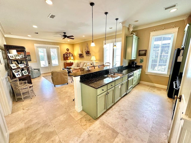 kitchen with kitchen peninsula, green cabinets, a healthy amount of sunlight, and sink