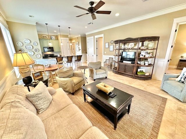 tiled living room with ceiling fan and crown molding