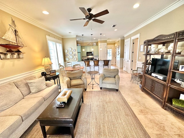 living room featuring ornamental molding and ceiling fan