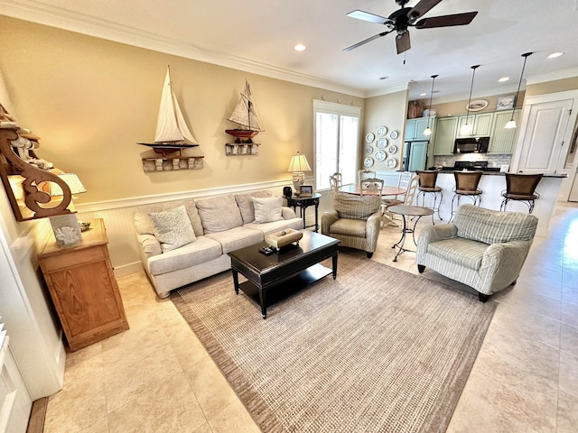 living room with ceiling fan, light tile patterned floors, and ornamental molding